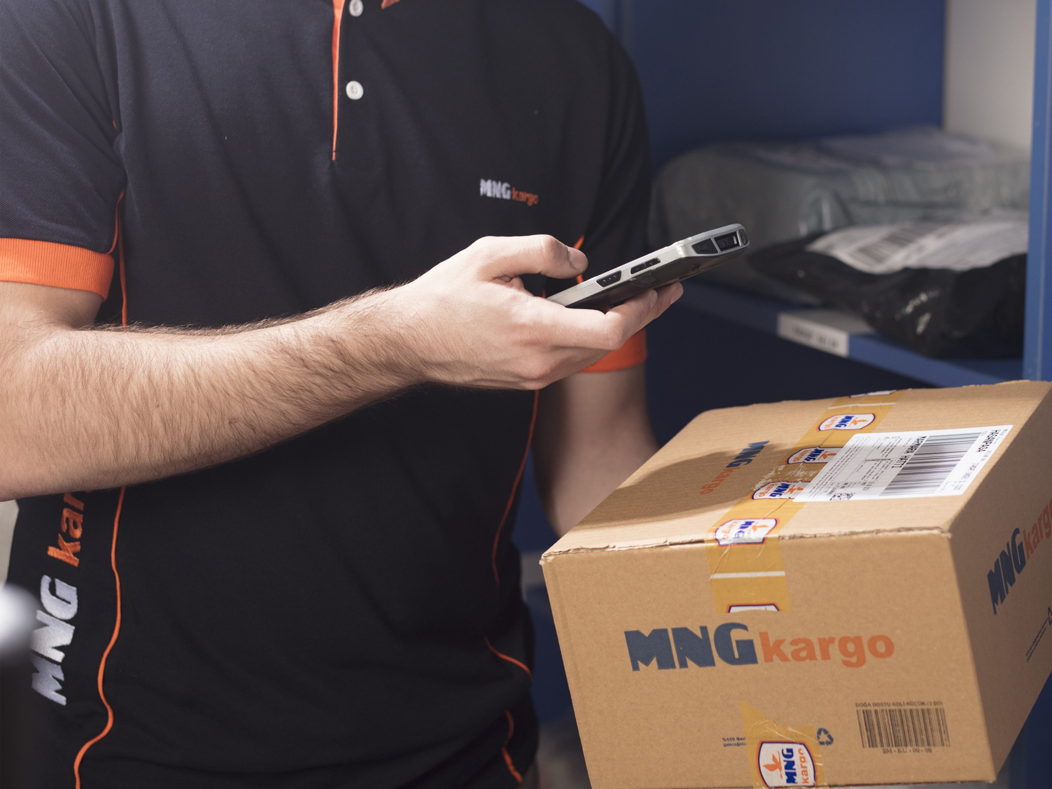 MNG Kargo employee scanning a box