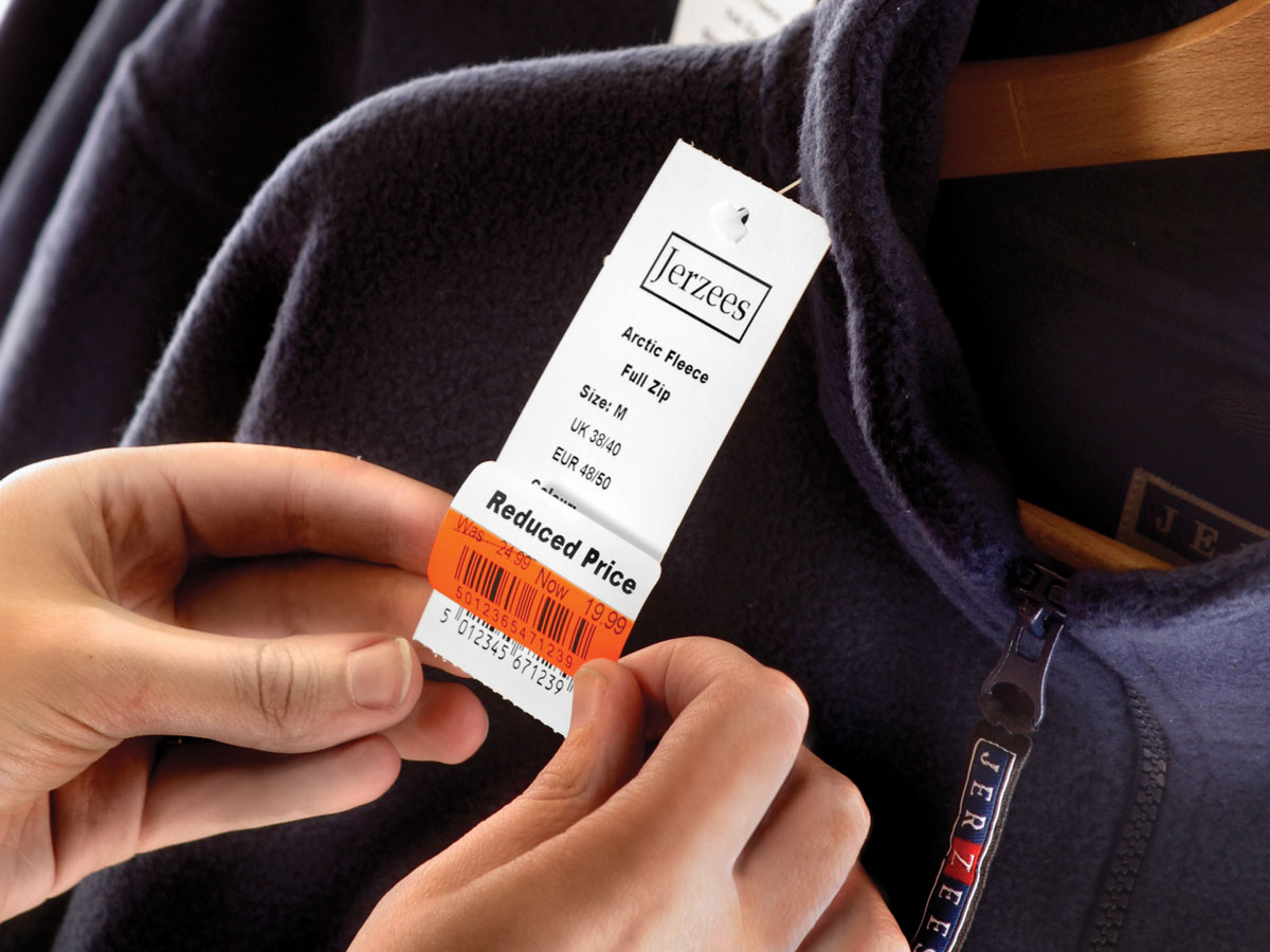 Zebra price tag being applied to a fleece jacket